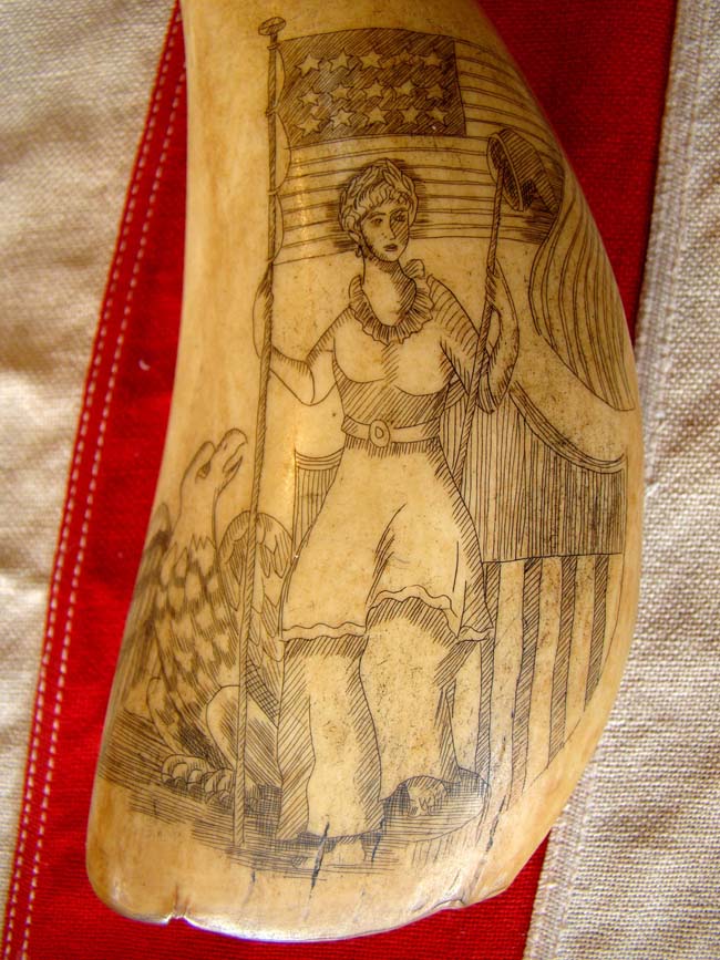 A beautiful late 19th or early 20th century patriotic themed scrimshawed whale's tooth